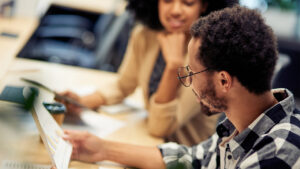 A photo of two business colleagues discussing a financial chart