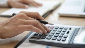 hand on a calculator