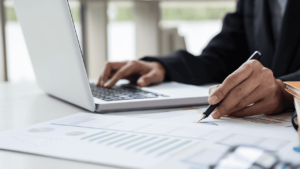 Business owner evaluates risk on laptop