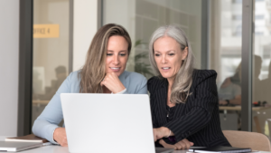 Two women looking at a laptop