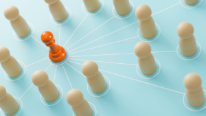 Wooden pawns positioned on a map of interconnected lines with an orange pawn in the center.