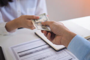 An employer adding a contribution to a jar of coins for a 530A account.